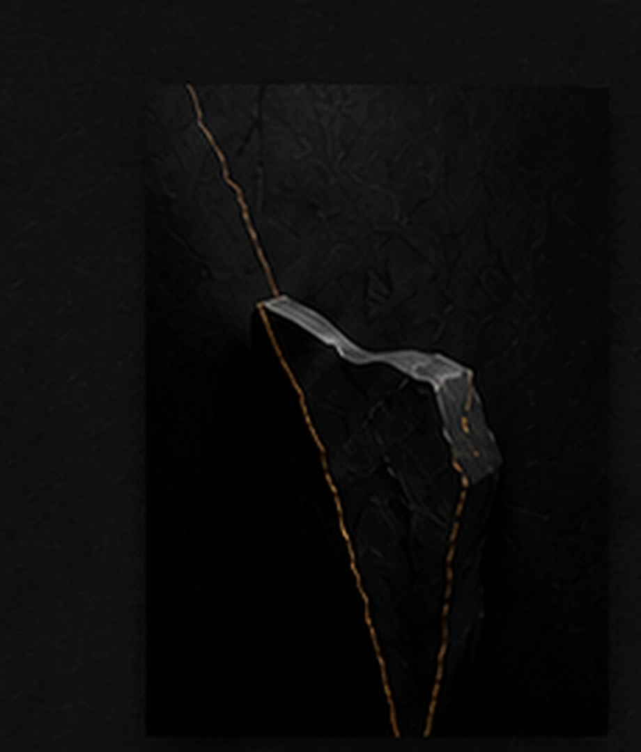 Sculptural black stone with a subtle gold vein